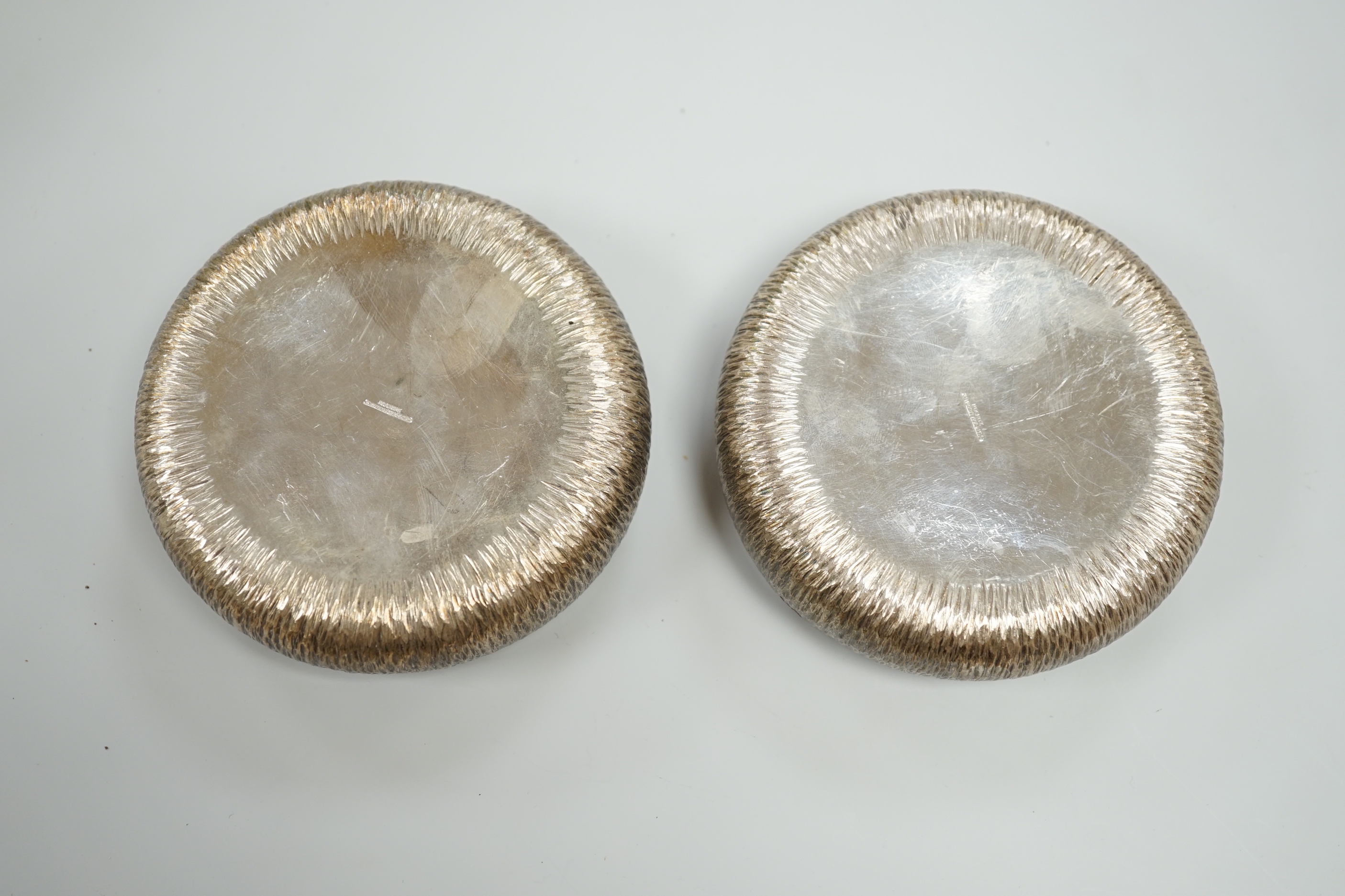 A pair of Elizabeth II textured silver wine coasters by Adrian Gerald Benney, London, 1979, diameter 10.3cm, together with a similar beaker, same maker, London, 1985, height 84mm, 15.7oz.